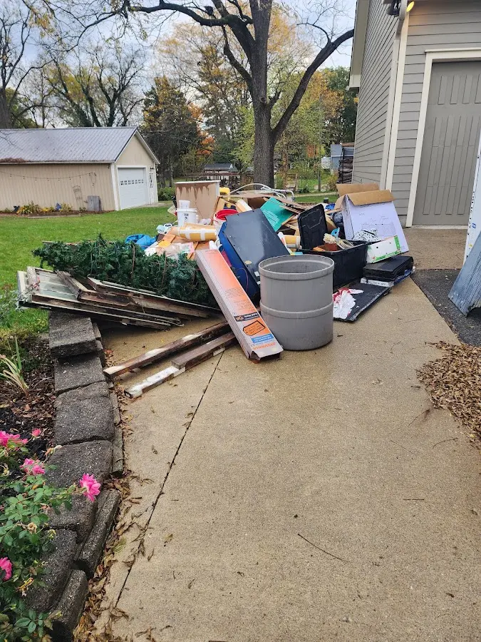 Dumpster being loaded with debris for Demolition Dumpster Rental in Phelps